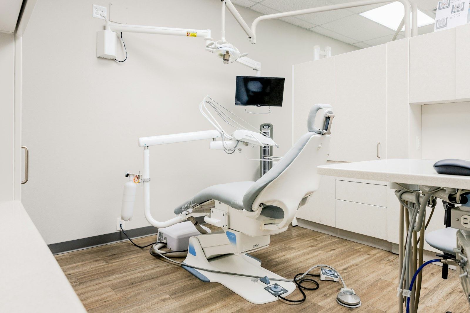 Bright dental treatment room with a patient chair