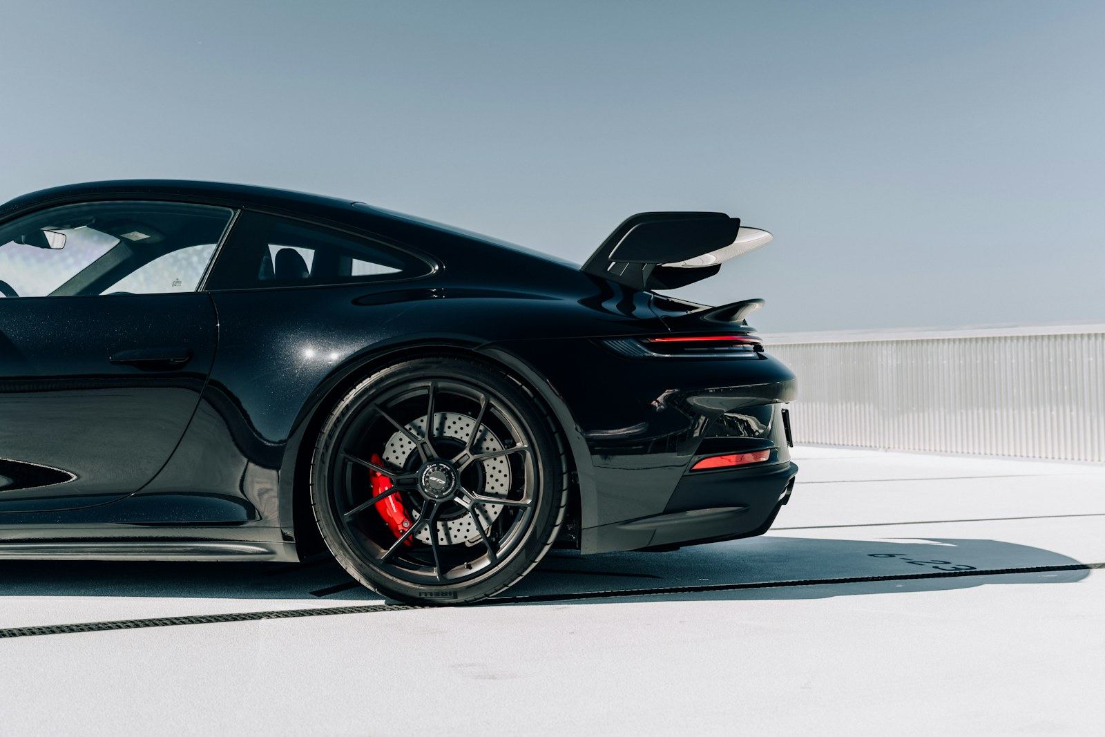 Dark luxury car with reflected light on its bodywork